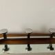 Vintage wall-mounted coat rack in chrome metal with integrated mirror and hat rack