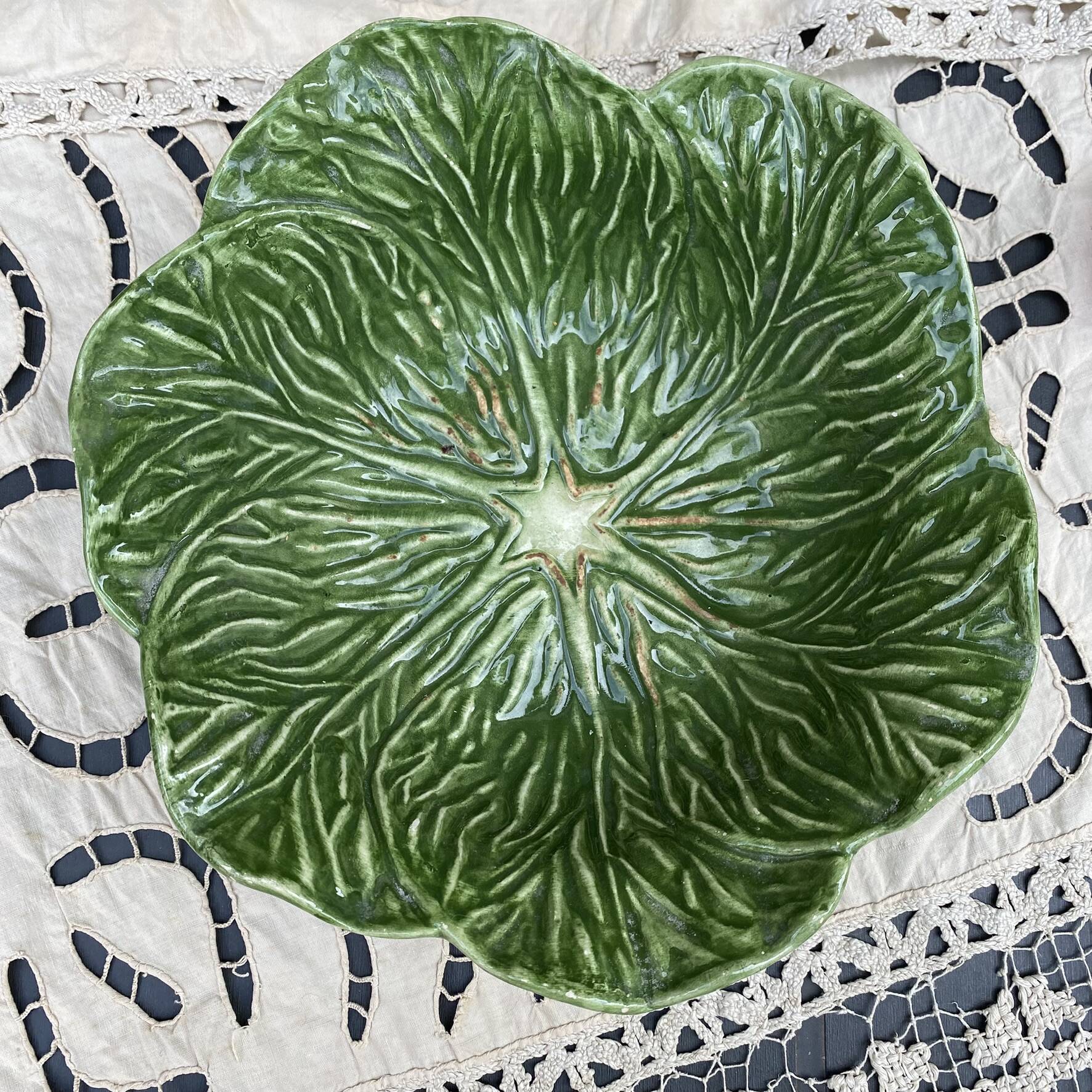 Large earthenware salad bowl in the shape of a cabbage leaf.