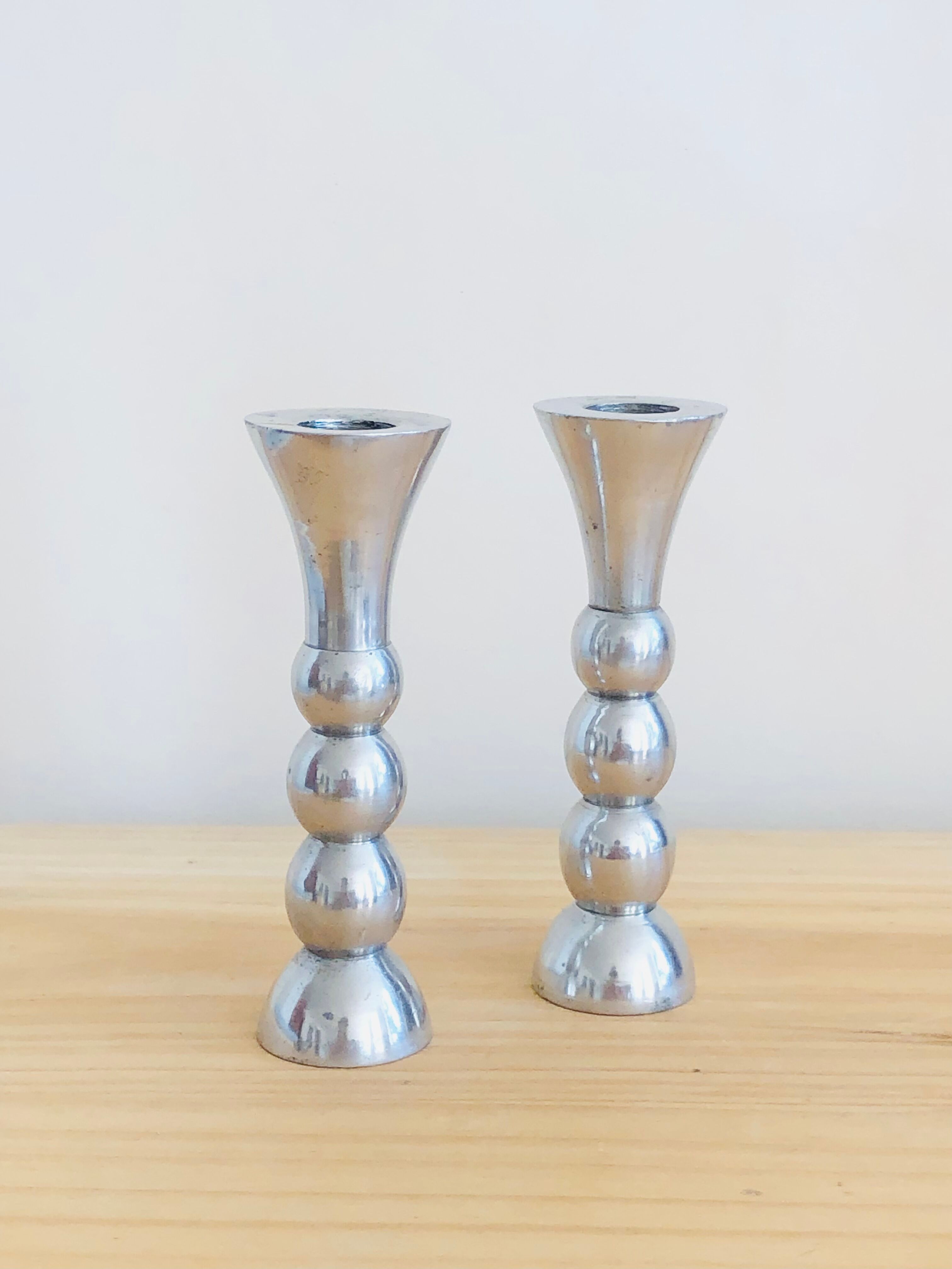 Pair of vintage cast aluminum candle holders