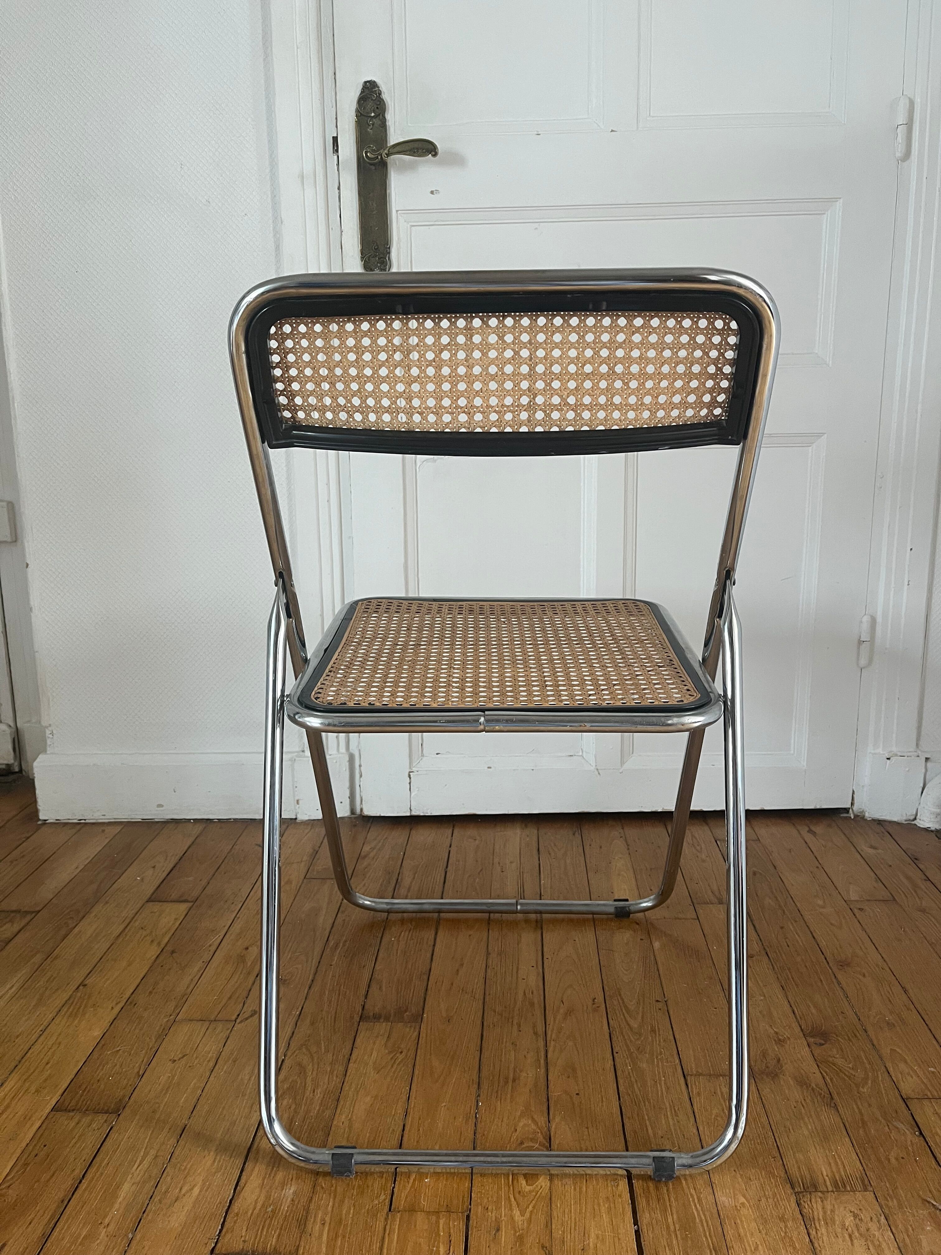 Vintage folding chair in metal and cane.
