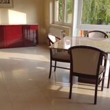 Square table in burgundy marble, its 4 matching chairs in white fabric and its buffet