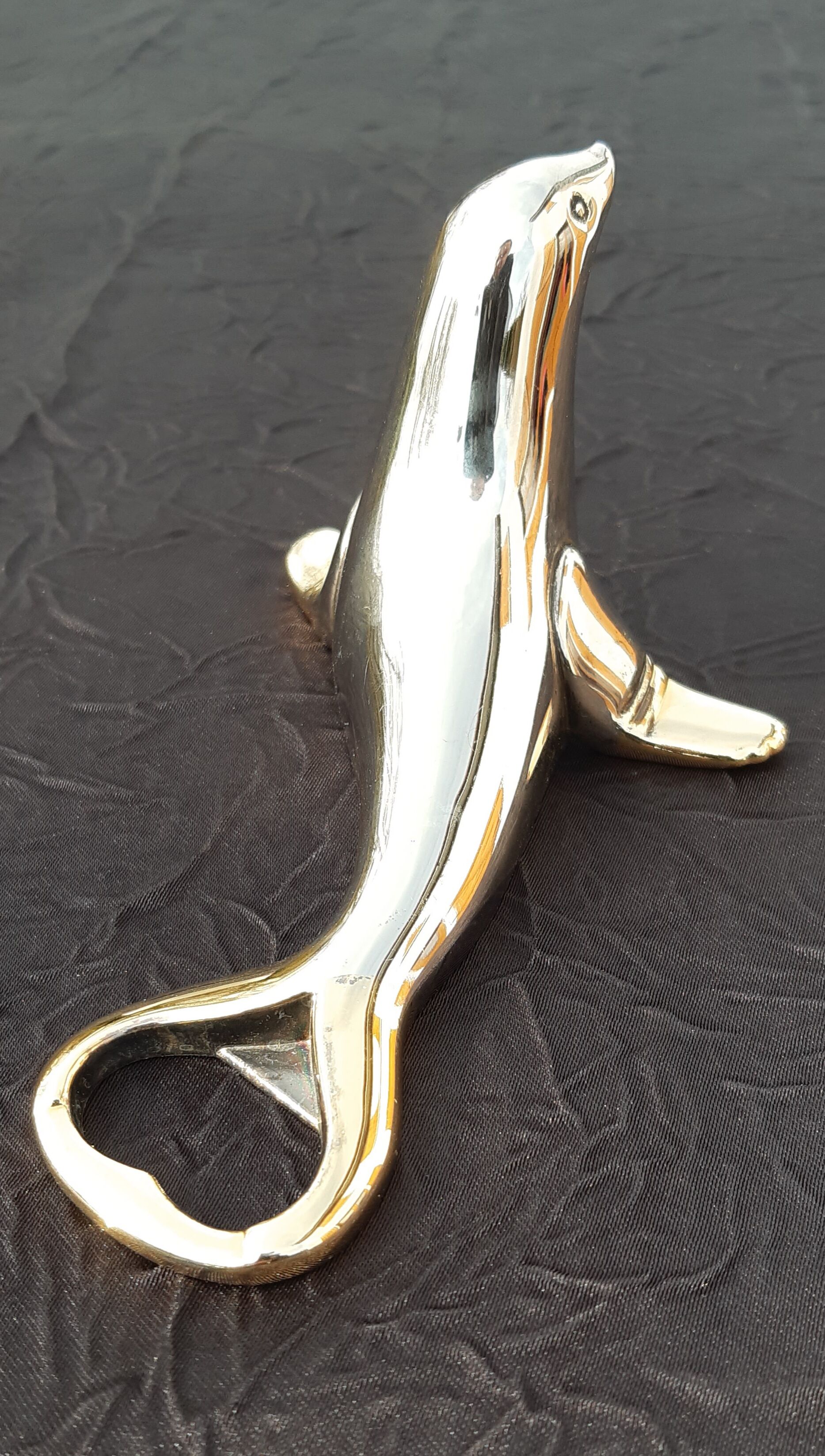 Silver and gold metal sea lion bottle opener