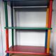 Shelf on legs, library, crayons in 4 colours.