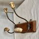 19th-century wall coat rack with 2 metal and horn hooks.