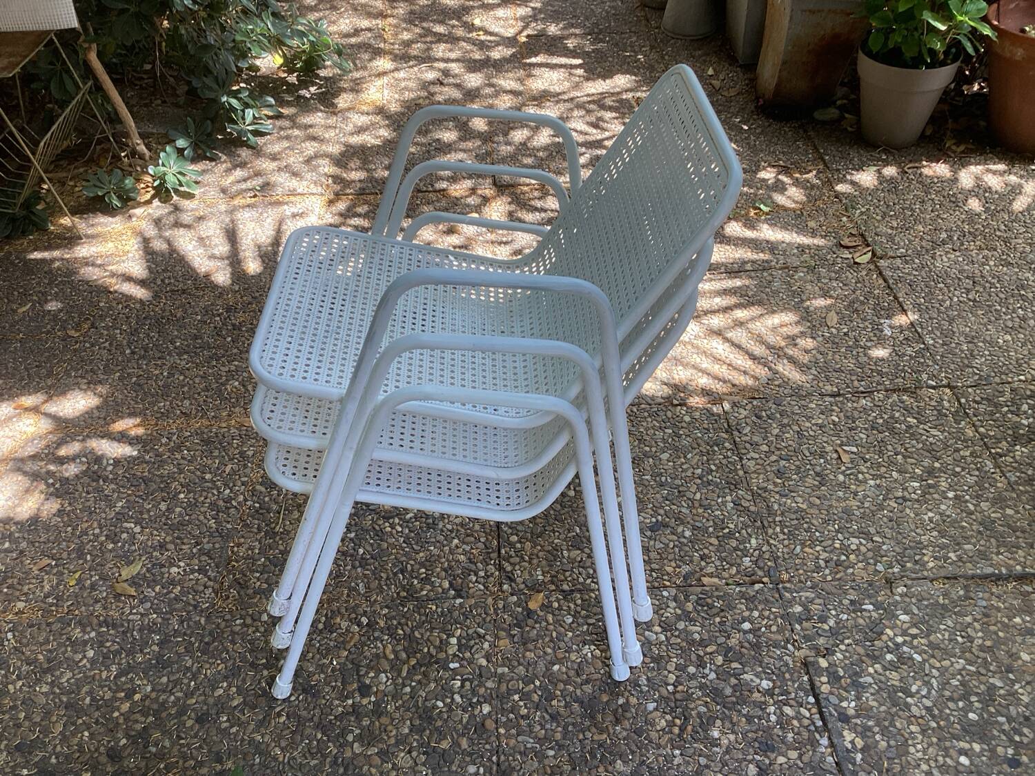 Perforated metal armchairs