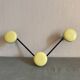 2 black and yellow metal wall coat racks