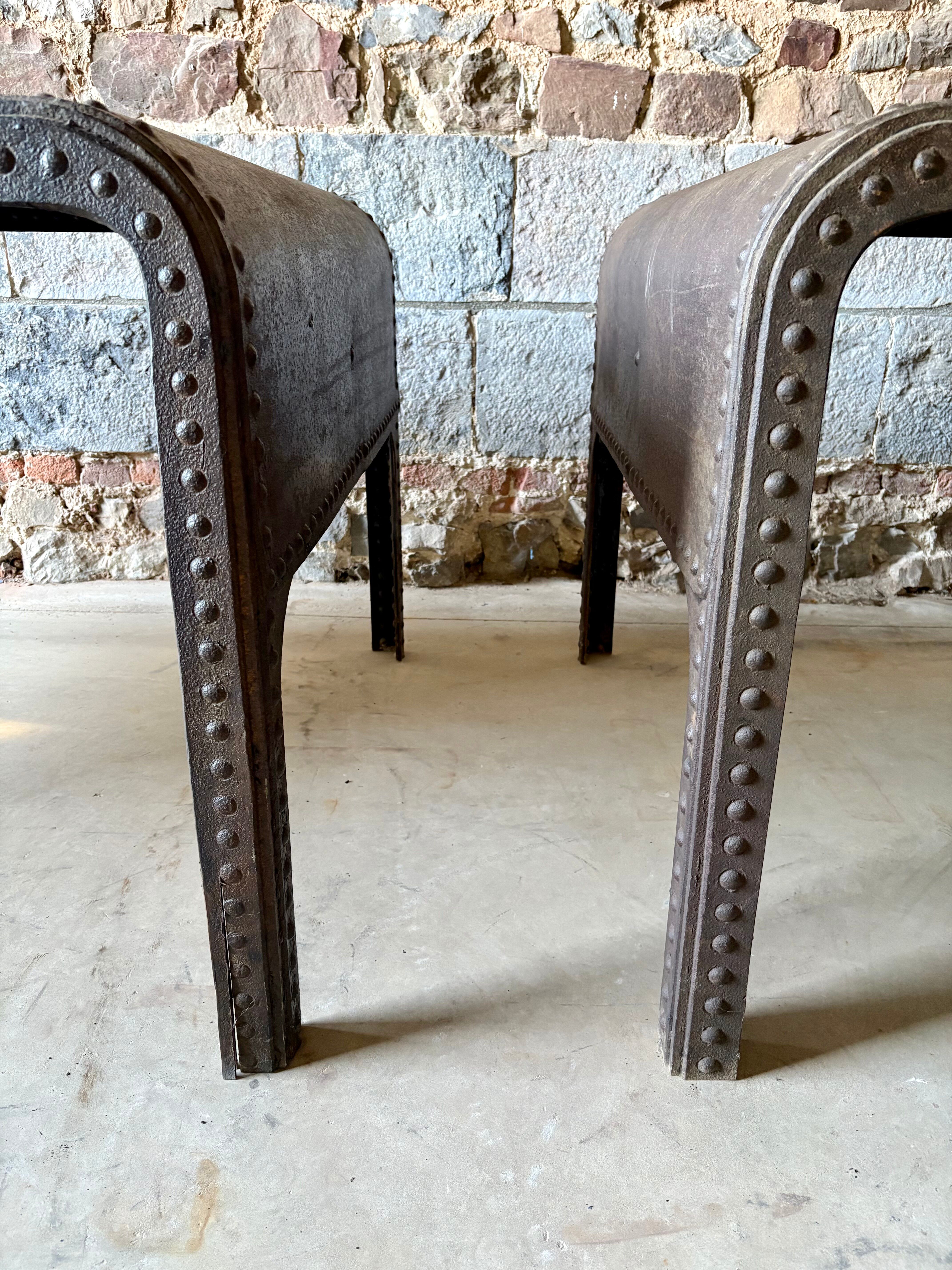 Pair of large riveted metal industrial tables
