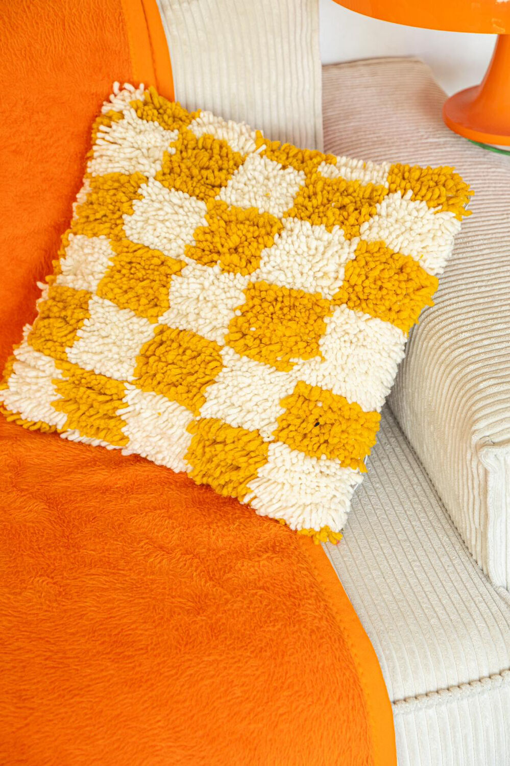Berber cushion with orange and white checkerboard