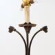 Wrought iron tripod floor lamp decorated with stylized animal heads