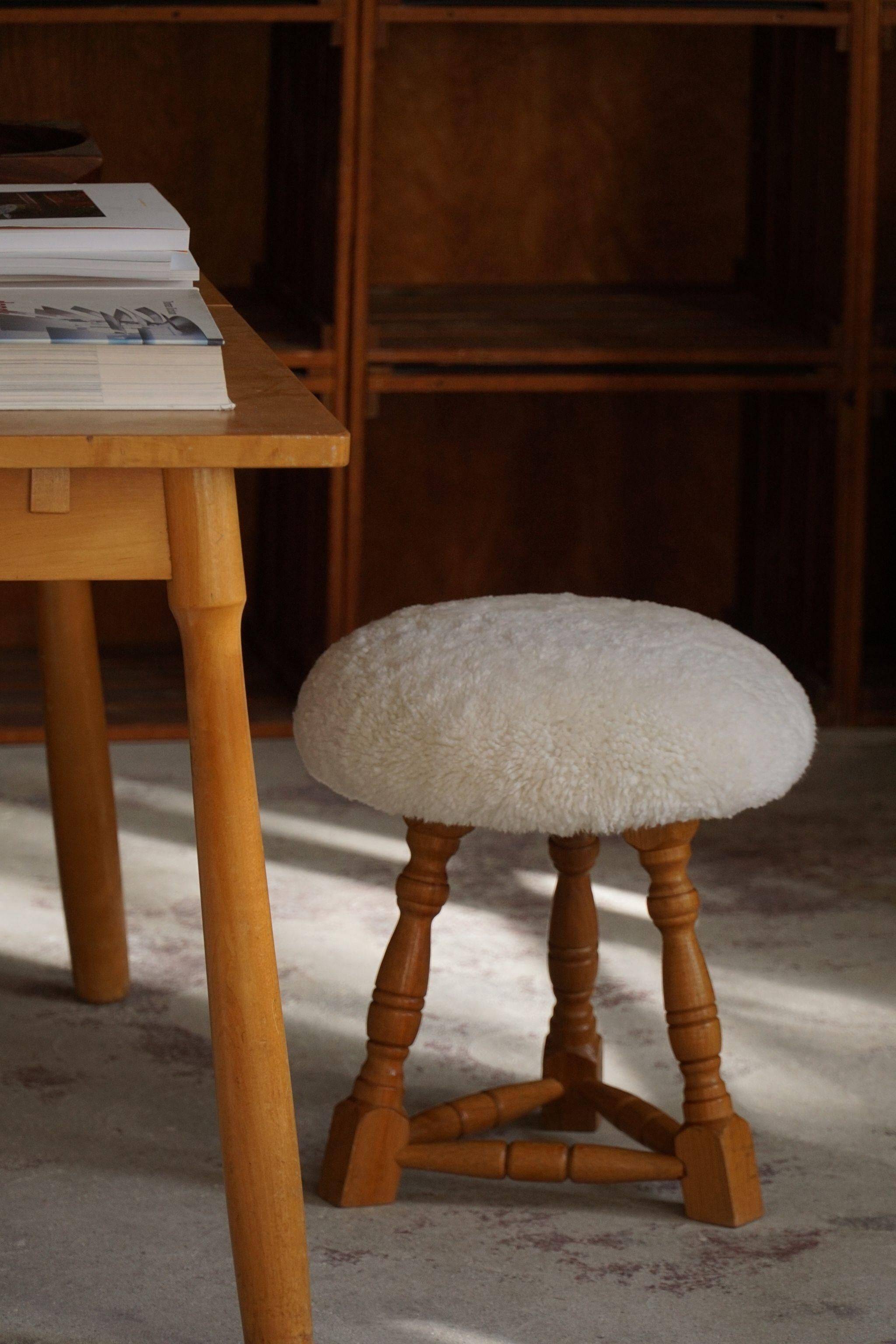 Modern Danish, a pair of tripod stools, seats reupholstered in lambswool, 1950s.