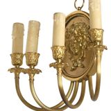 Pair of wall sconces with a relief decoration of a Bacchus mask.