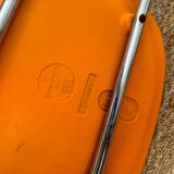 Two orange plastic pollak chairs at Orly airport