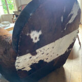 Pair of club chairs covered in cowhide