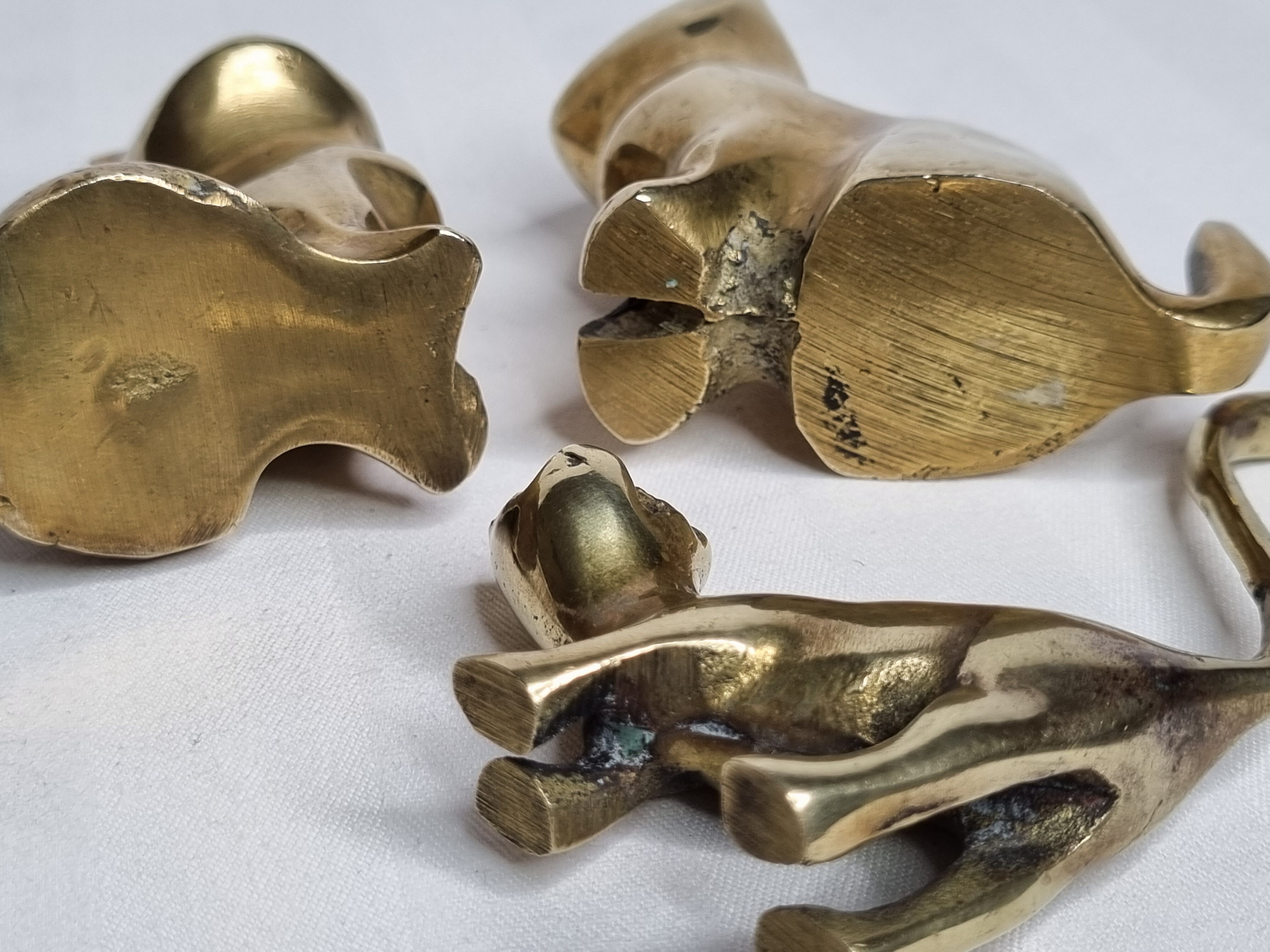 Set of three brass cats