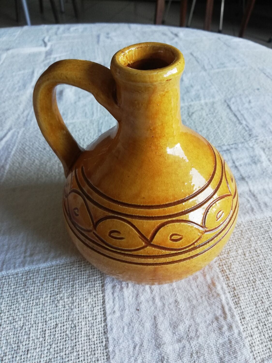 Round ochre glazed jug with handle