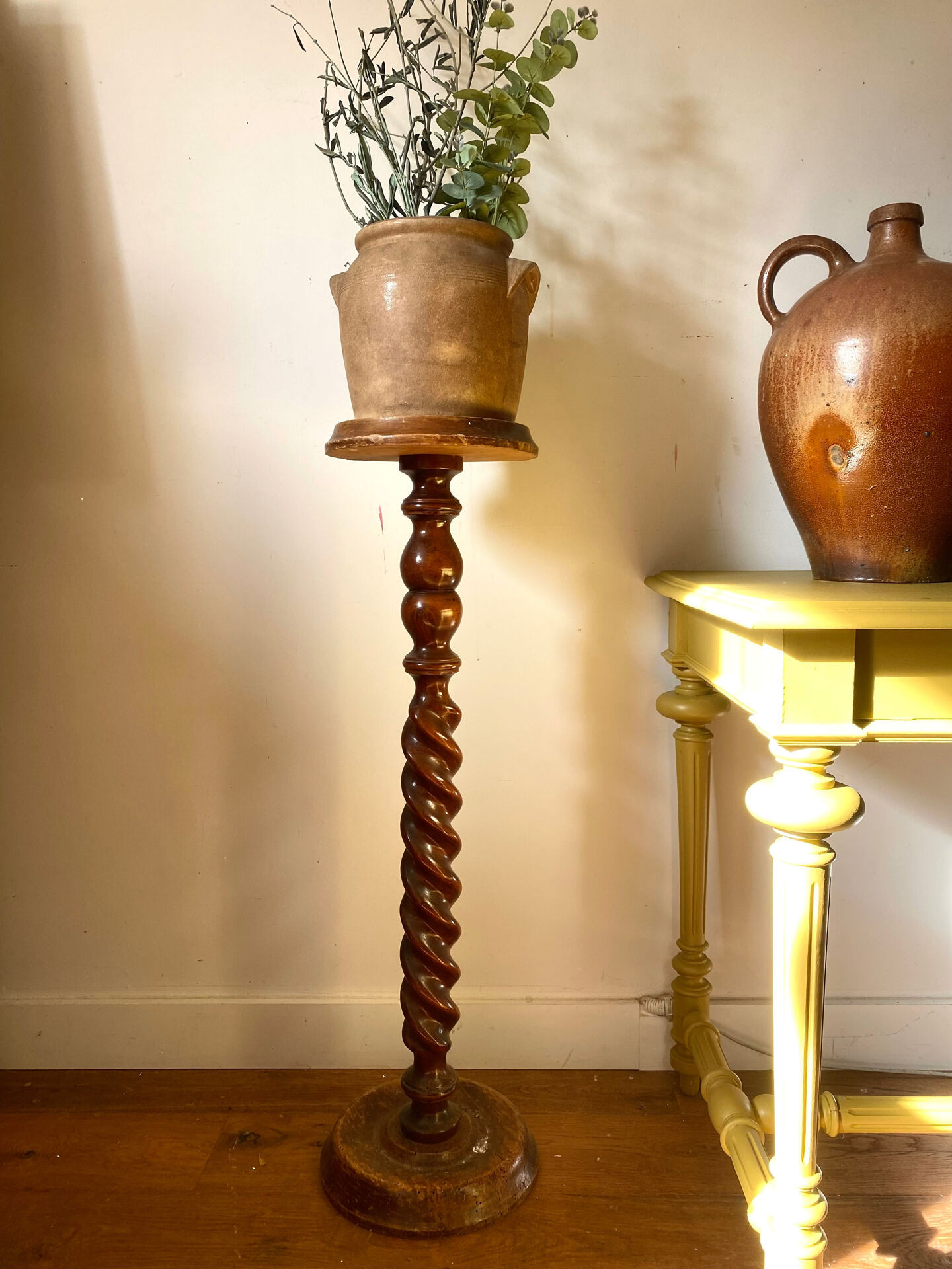 Antique pedestal table with a twisted column.