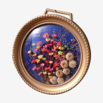 Round vintage frame of dried flowers, domed frame