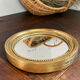 Miroir rond en bois de couleur dorée