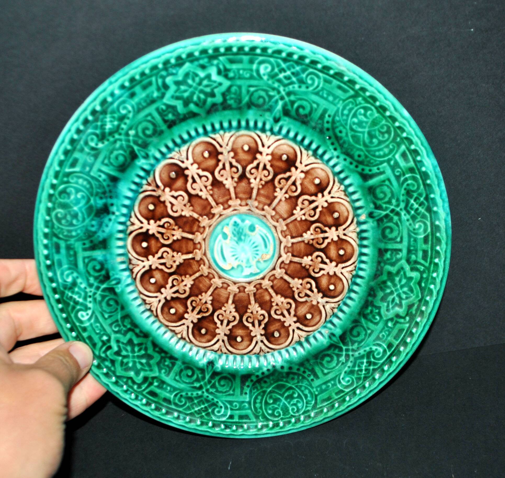 Antique plate in turquoise brown green slip with arabesque decoration