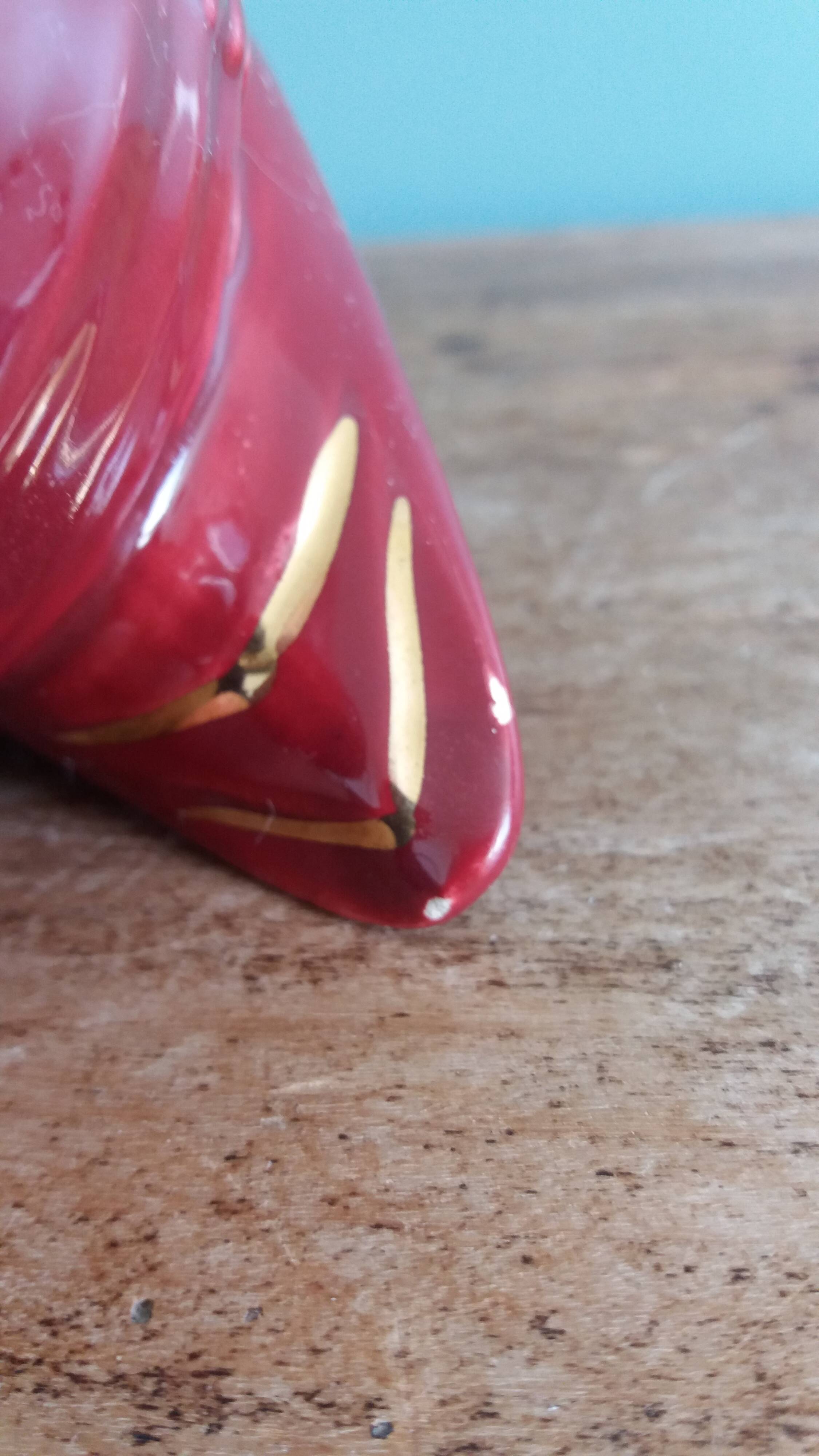 Poet Laval swan hides zoomorphic pot in burgundy ceramic.