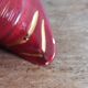 Poet Laval swan hides zoomorphic pot in burgundy ceramic.
