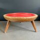 Wooden and red plastic compasses plant stand.