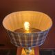 Lamp base in gilded brass, oval silk lampshade with a checkered pattern in burgundy.