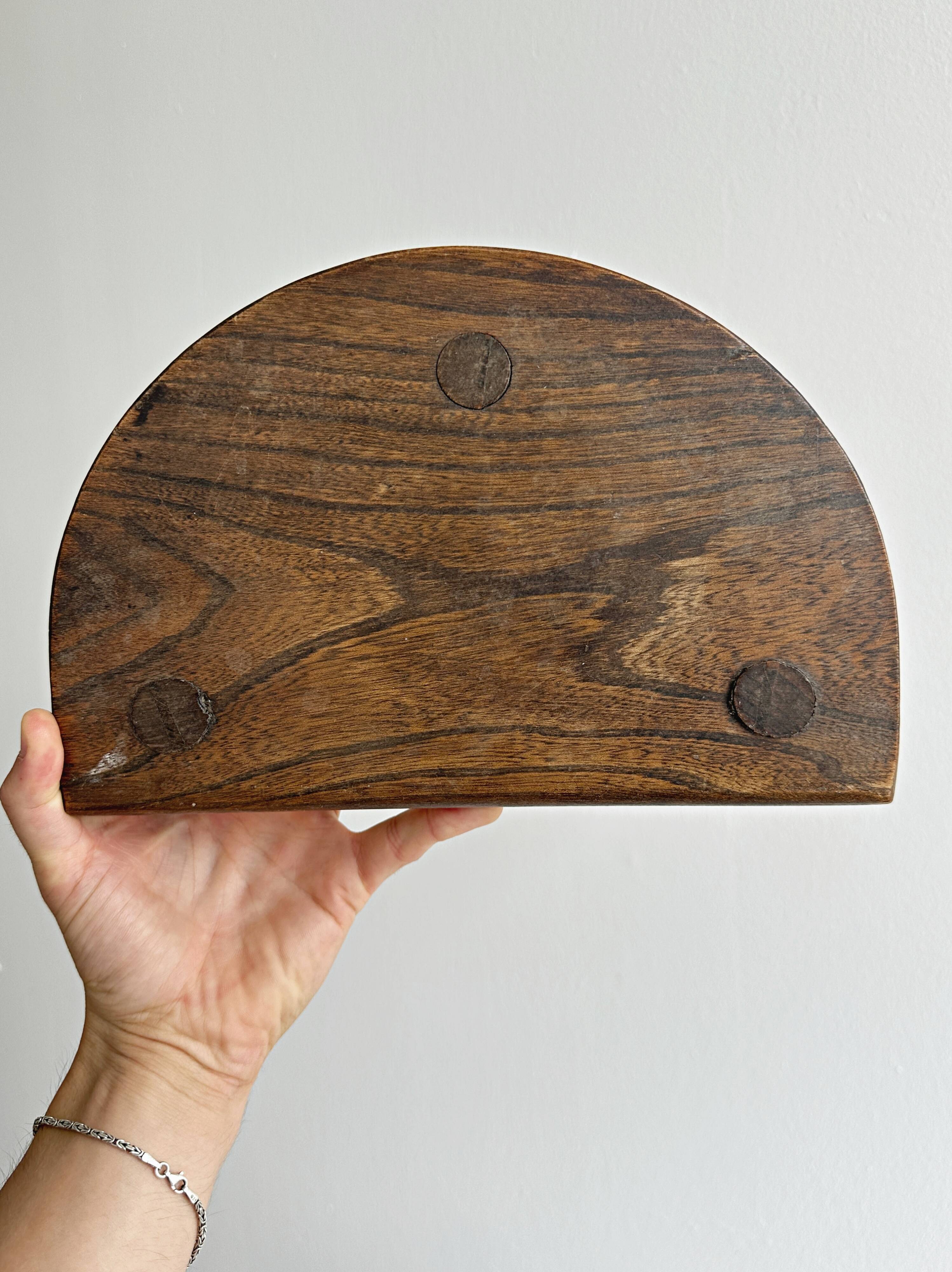 Three-legged demi-lune stool made of turned wood