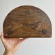 Three-legged demi-lune stool made of turned wood