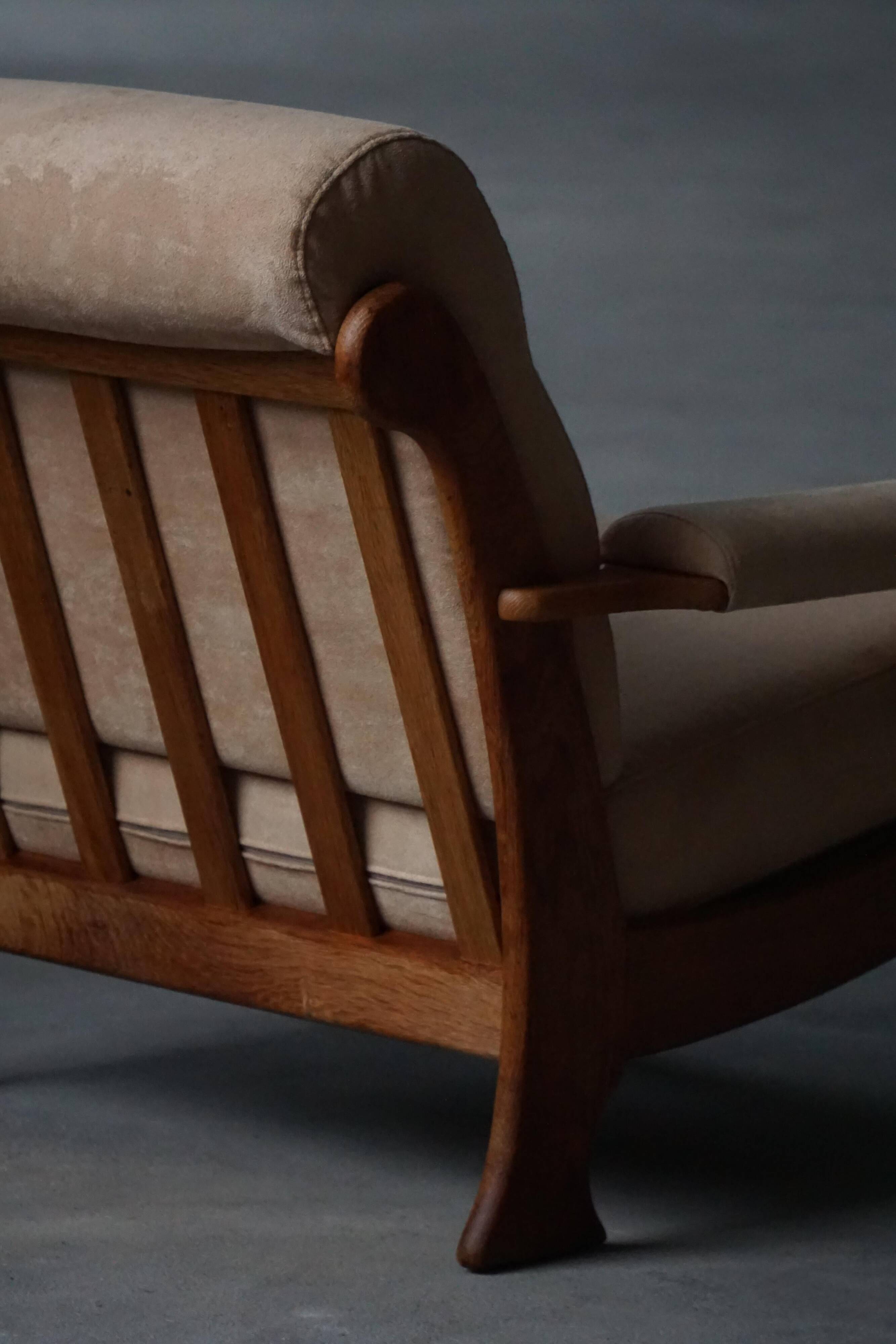 Mid-20th century, pair of armchairs by Henning Kjærnulf, oak and alcantara, 1960s.