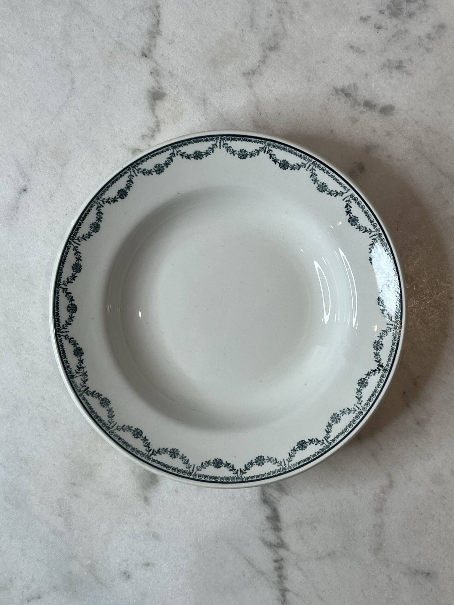 Set of 12 deep plates Saint Amand with floral garland decoration.