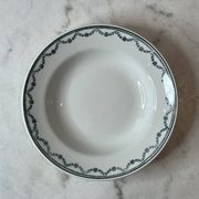 Set of 12 deep plates Saint Amand with floral garland decoration.