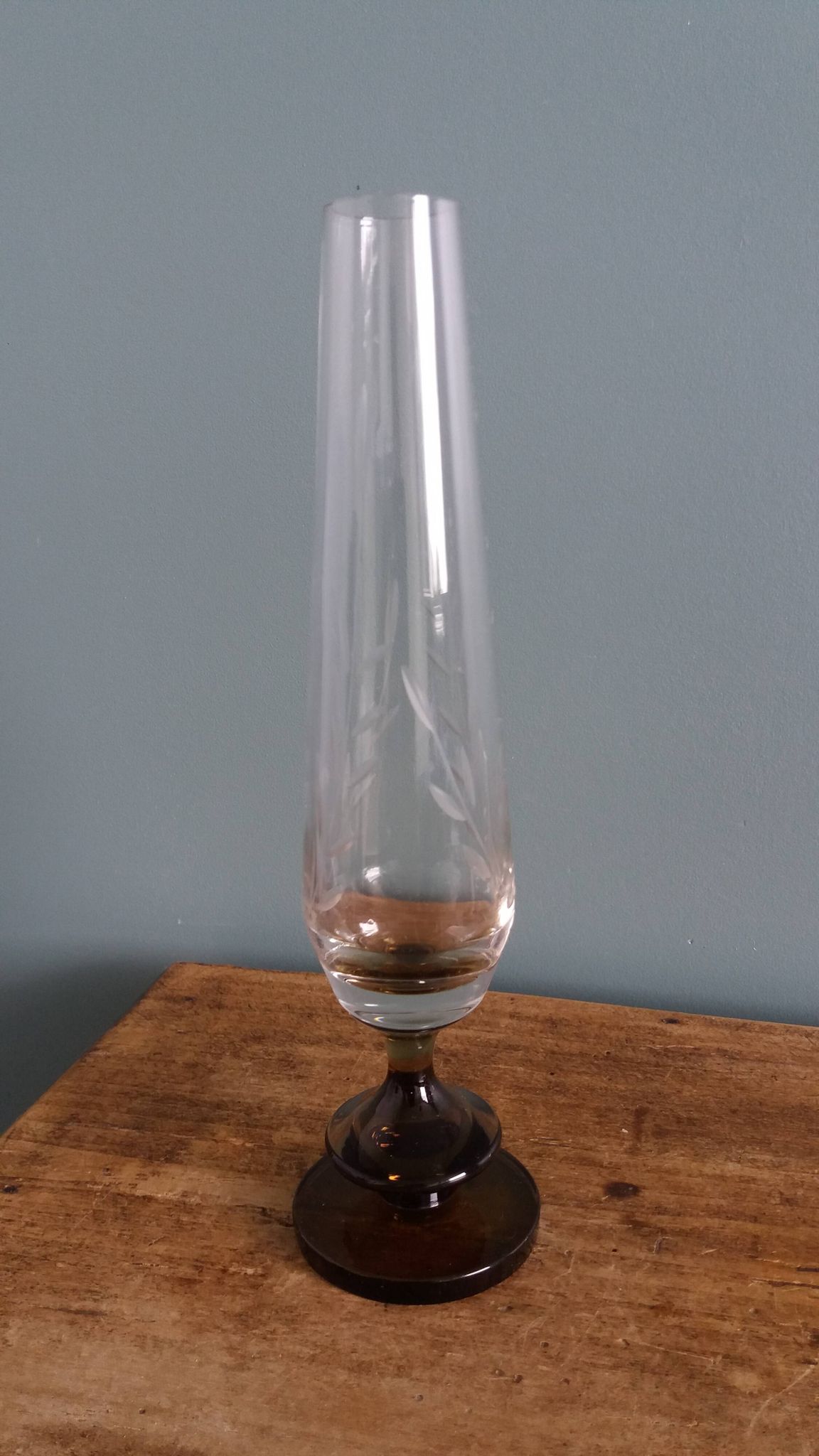 Cut glass soliflore vase with a smoked glass base.