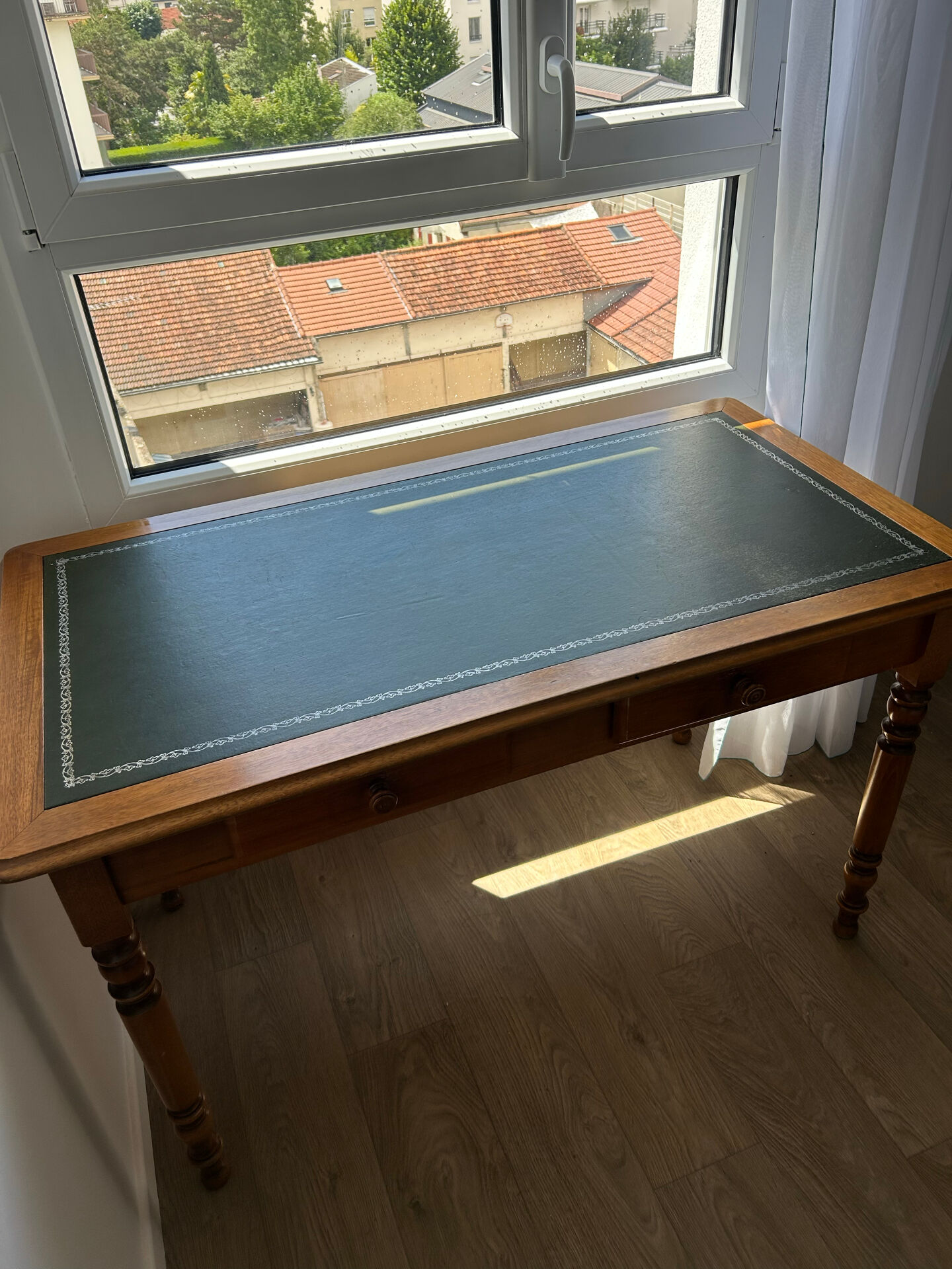 English-style wooden desk with a green leather writing pad.