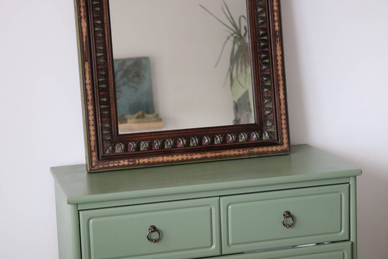 Antique mirror with a carved and painted wooden frame