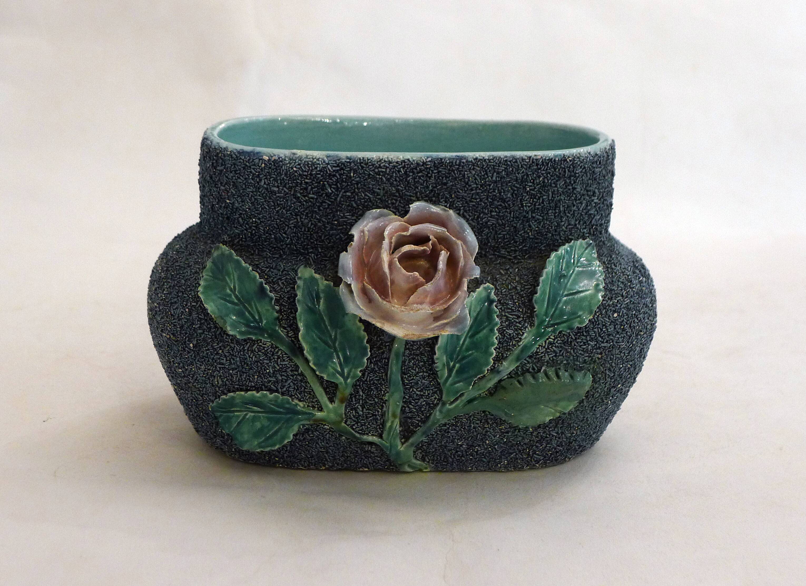 Antique jardinière with rose design in barbotine pottery.