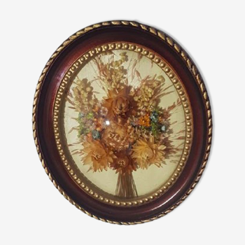 Curved oval frame with dried flower composition