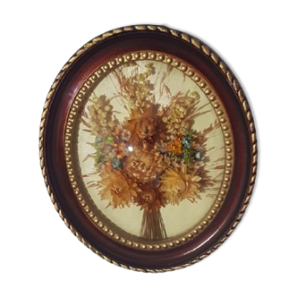 Curved oval frame with dried flower composition