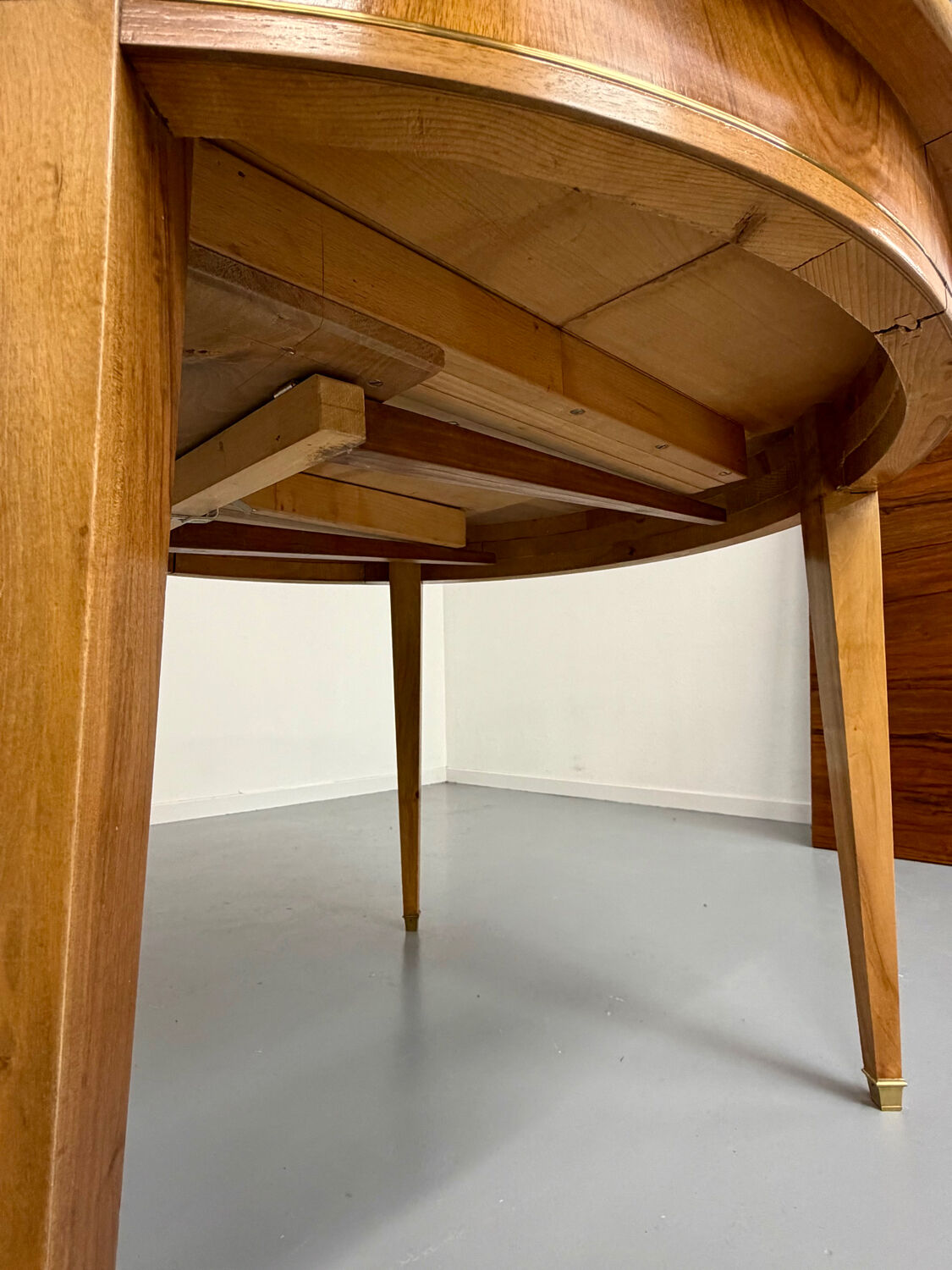 Round walnut Napoleon III extendable table with bronze top in good condition.