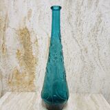 Blue pressed glass bottle decorated with flowers