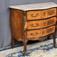 Louis XV style commode with rosewood veneer, gilded bronze mounts, and marble top.