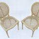 Pair of white canne and lay chairs