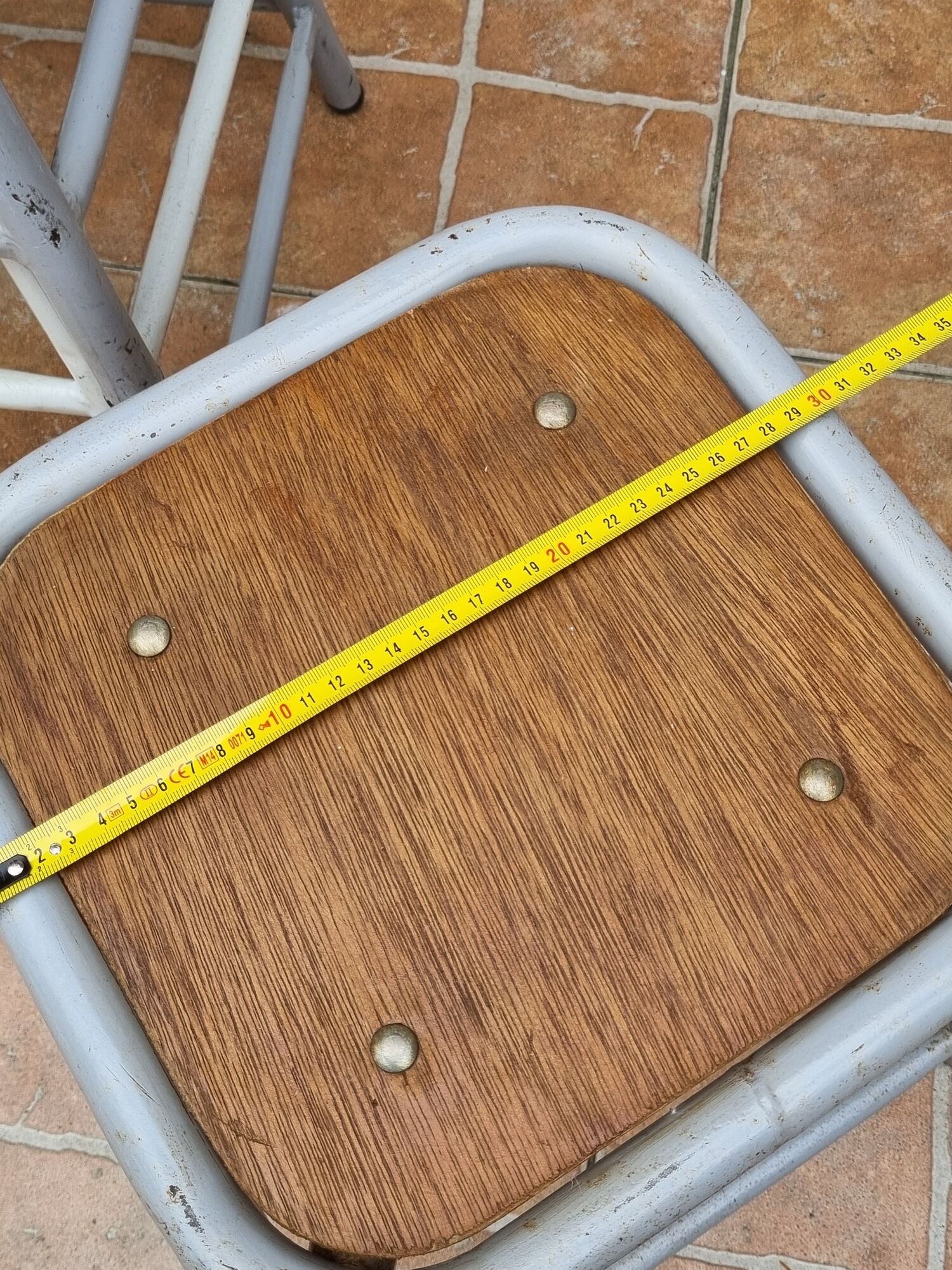 Set of four stackable industrial tubular metal and wood stools