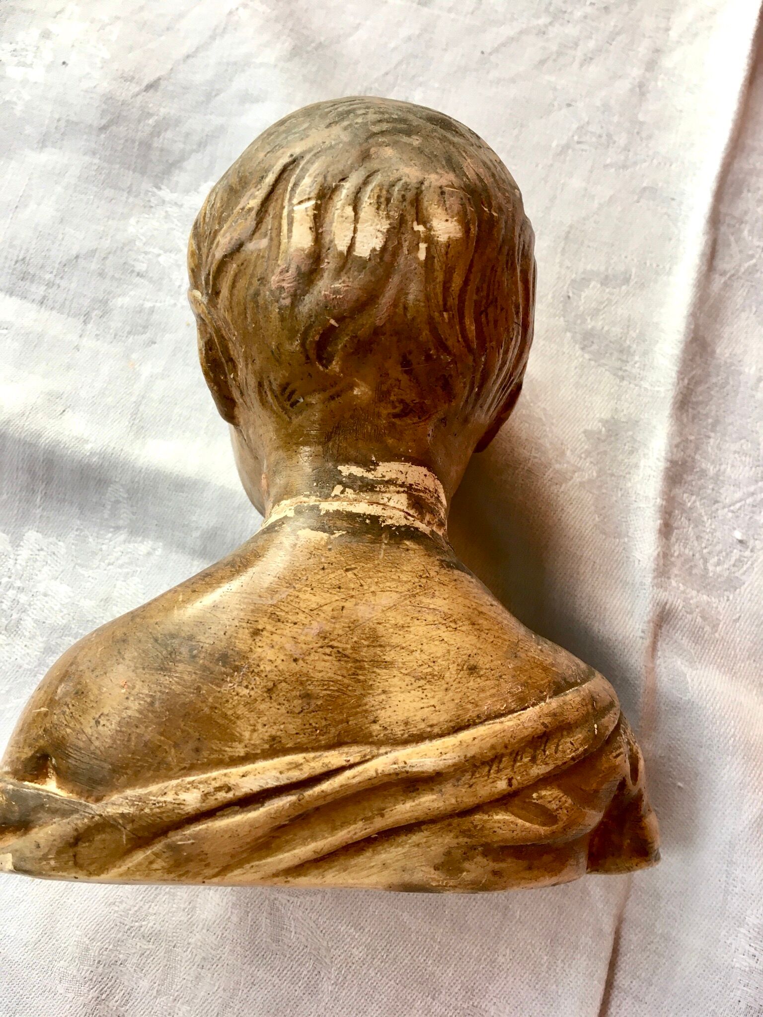 Carved earth bust