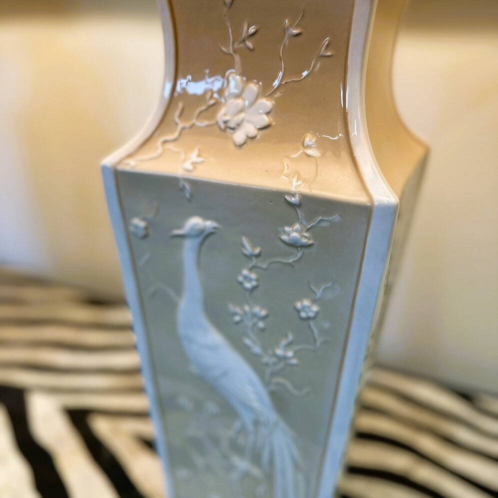 Pair of large cream ceramic table lamps with relief peacocks and fabric shades