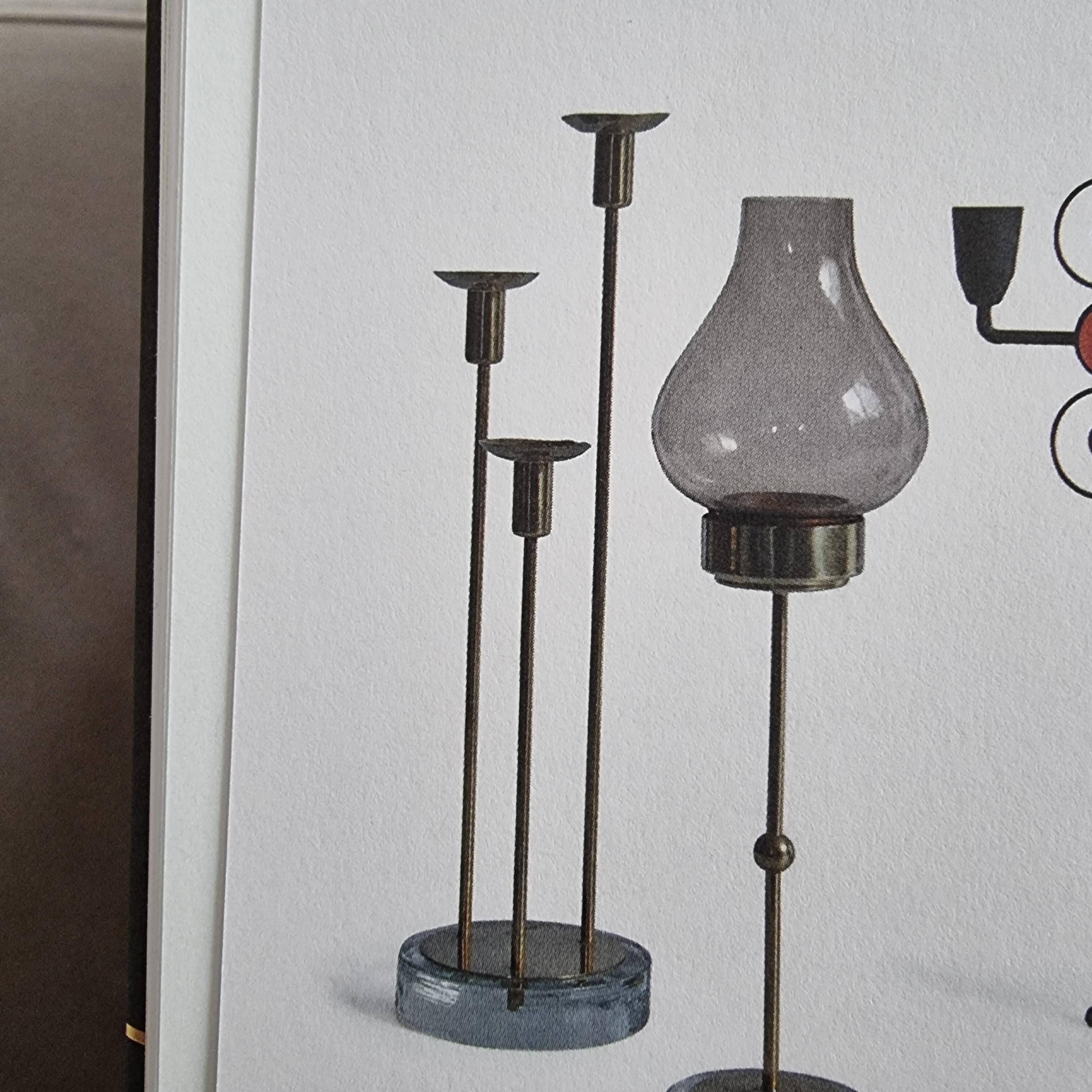 Gunnar Ander, four candlesticks, brass and glass, Ystad Metall, Swedish modern.