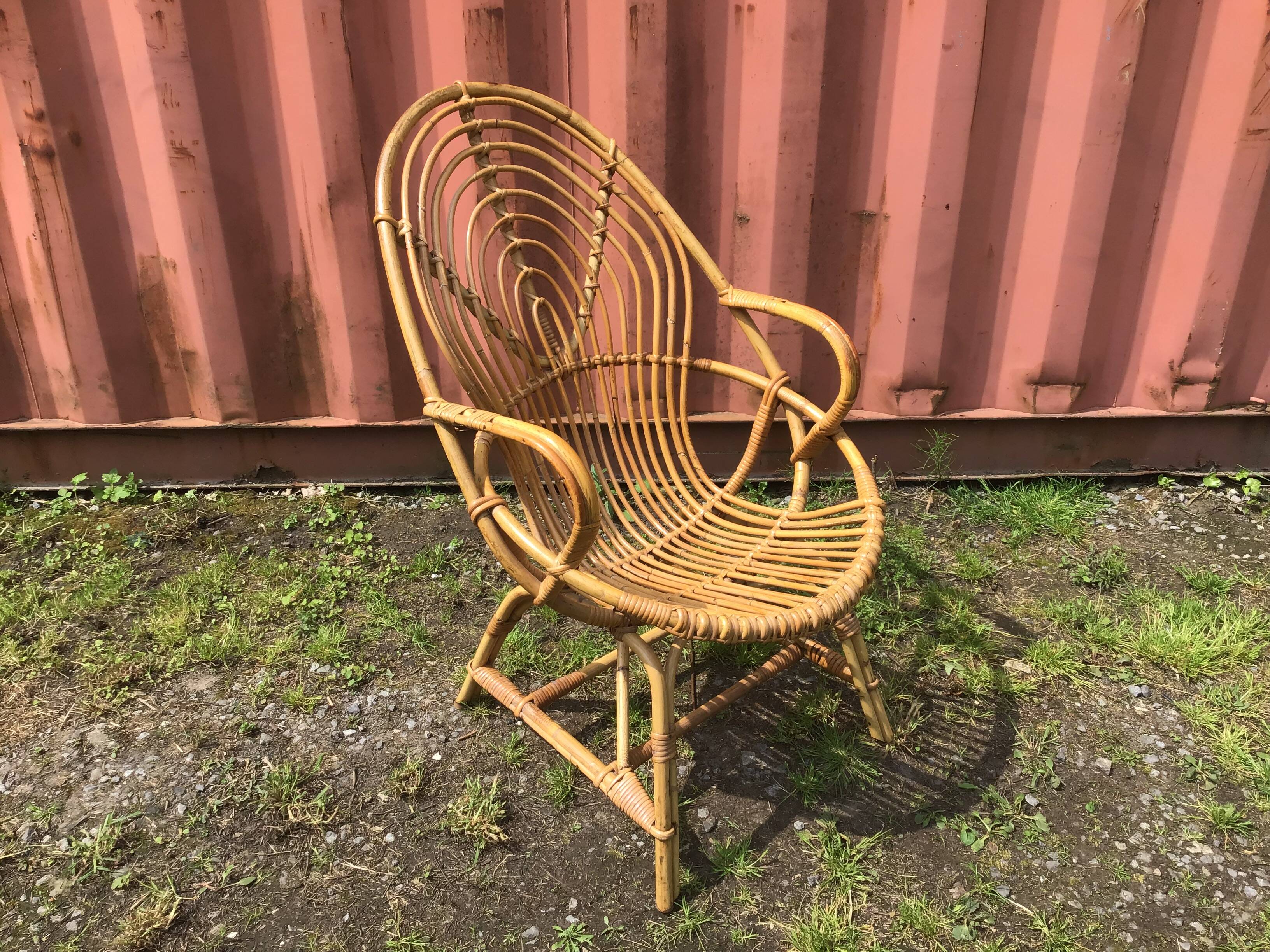 Vintage ovoid-shaped rattan armchair.