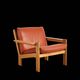 Brutalist armchair in oak and leather by Tage Poulsen, Denmark, 1970s.