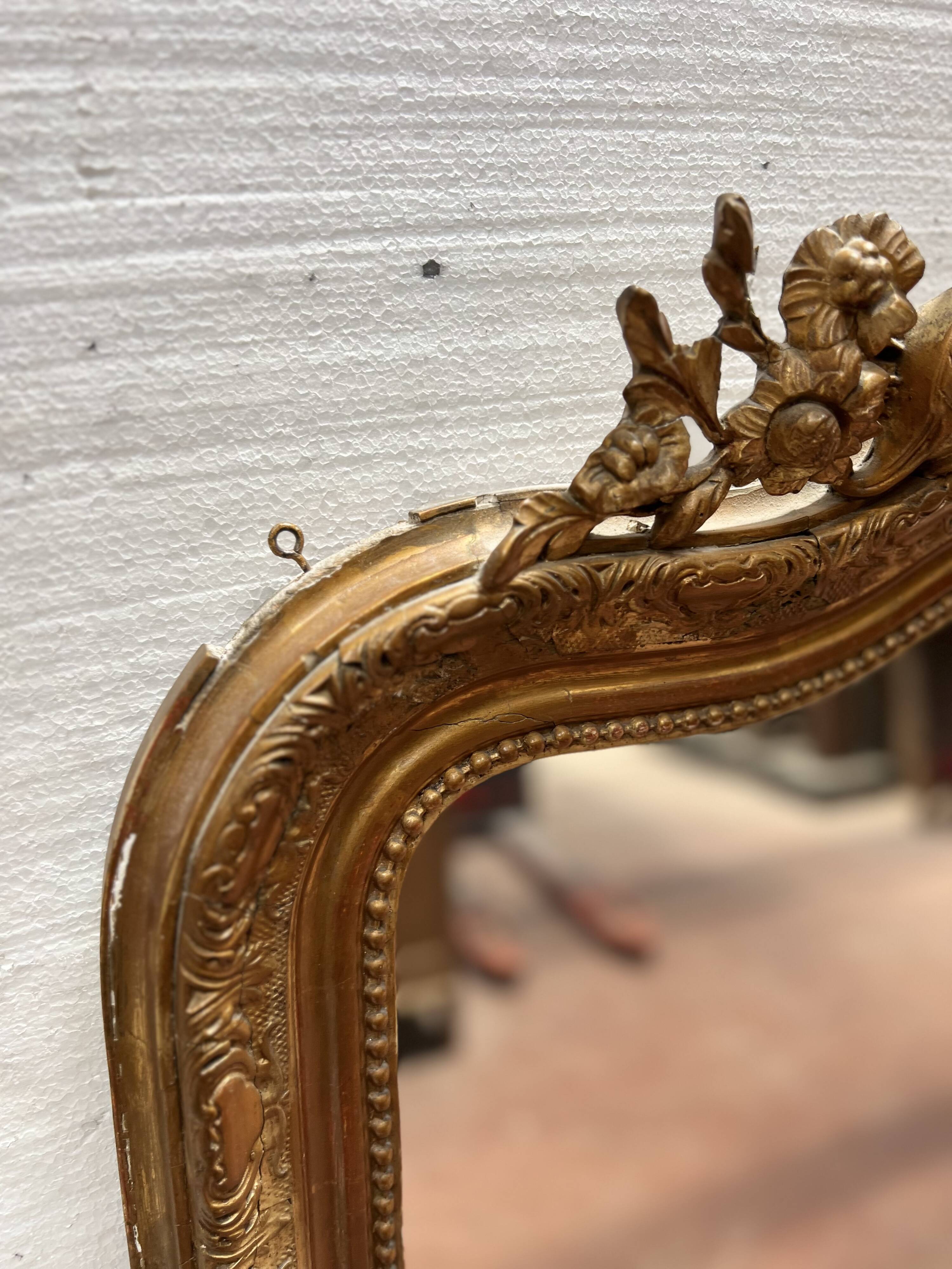 Louis XV style mirror in gilded wood and stucco, 20th century.