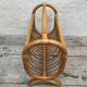 Magazine rack in braided rattan of the 60s